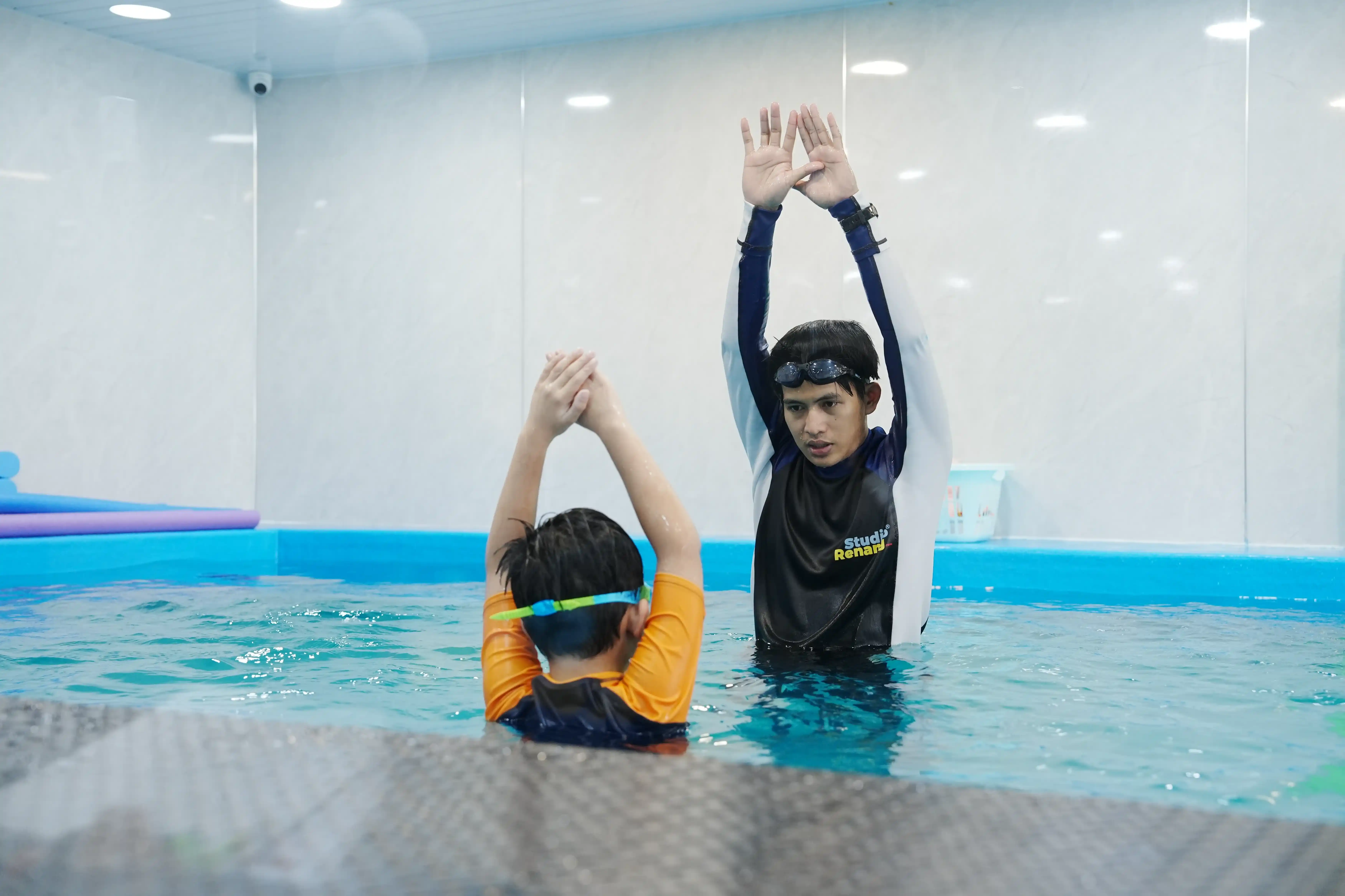Anak-anak bermain air di kolam renang
