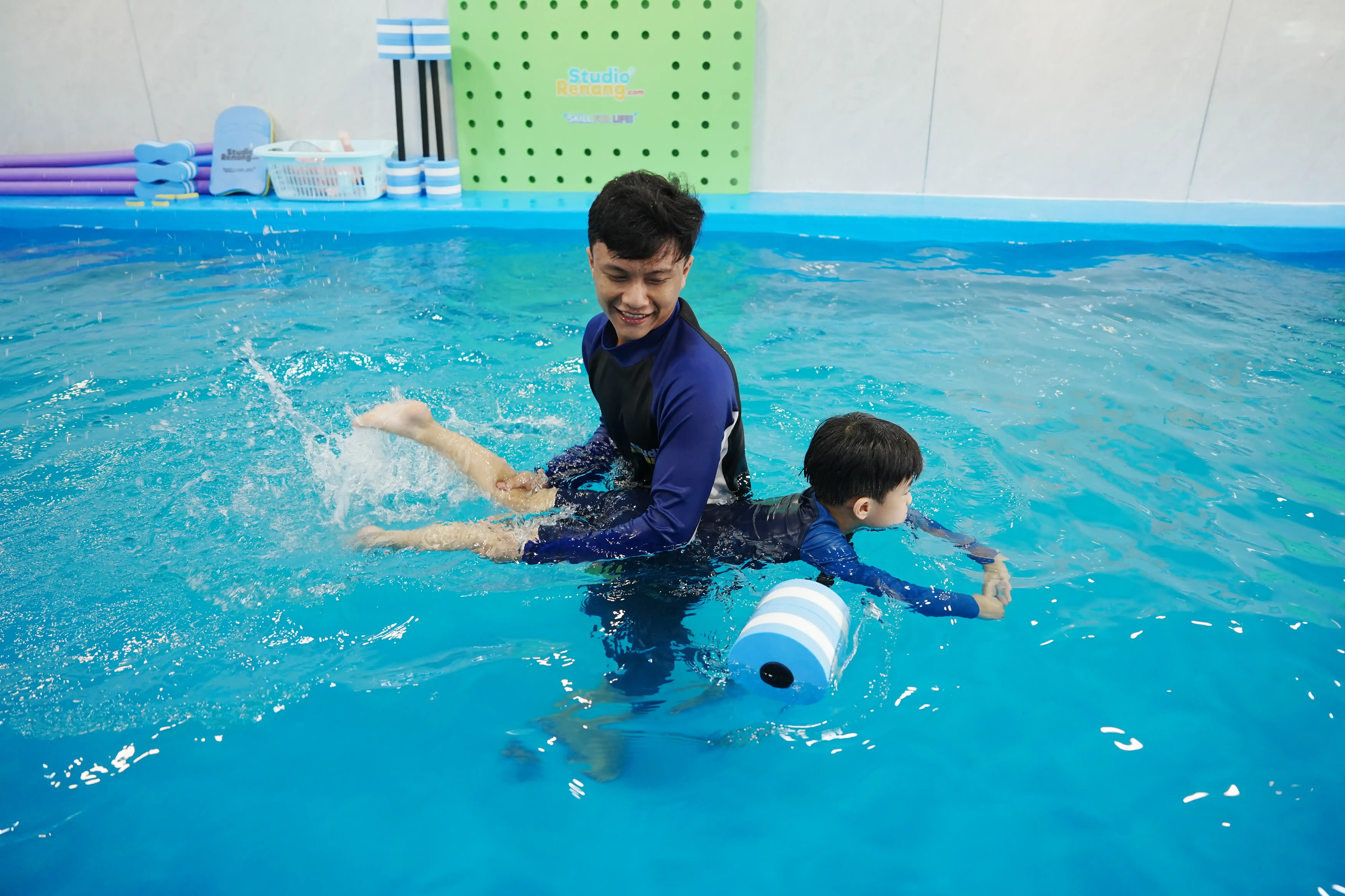 Anak-anak belajar berenang dengan alat bantu